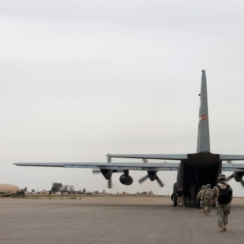 A soldier loads up onto an American plane near Mosul, Iraq.